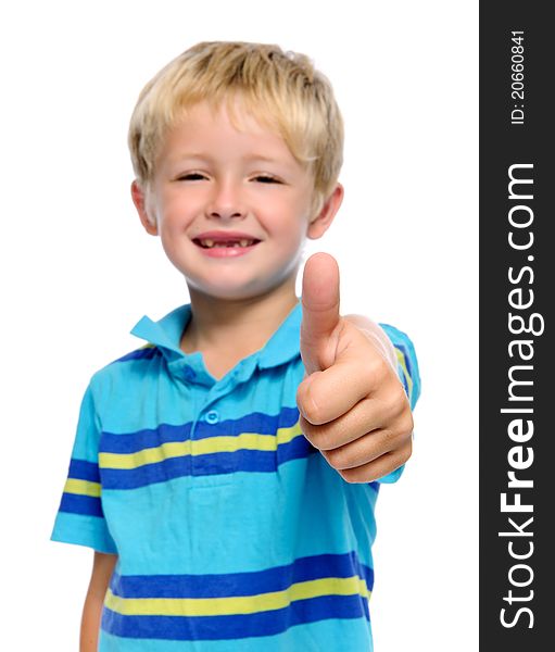 Happy young boy has his thumbs up; selective focus on hand. Happy young boy has his thumbs up; selective focus on hand