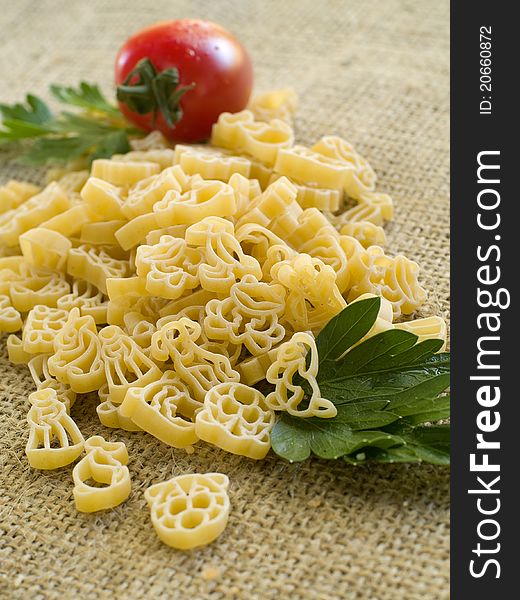 Pasta ingredients; fresh children makaroni, tomato, parsley
Selective focus