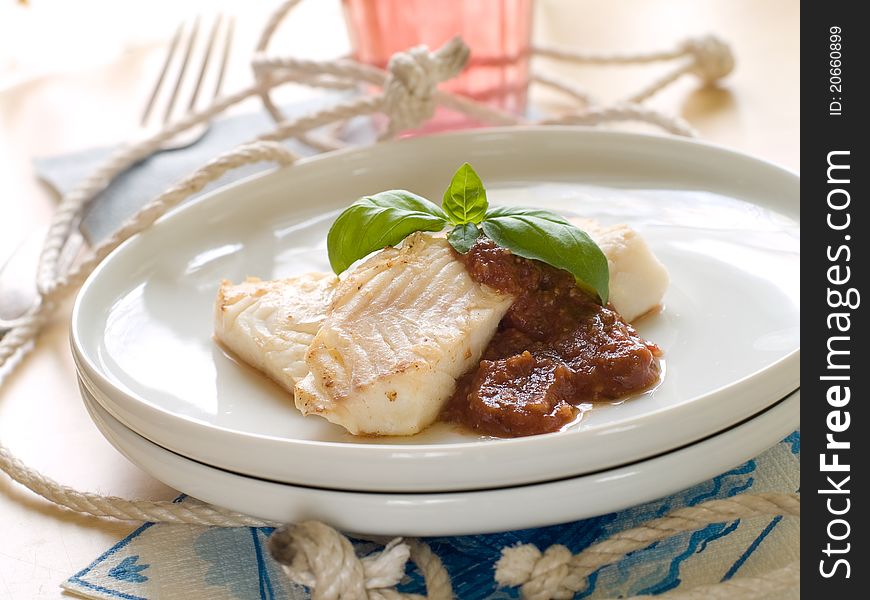Fish fillet with sauce and basil for your healthy dinner