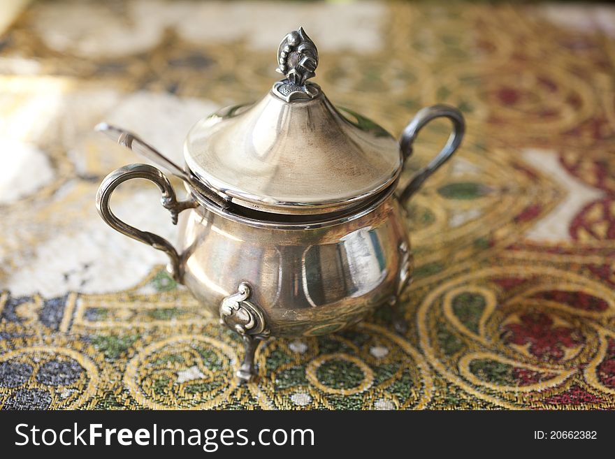 Old silver sugar bowl and spoon