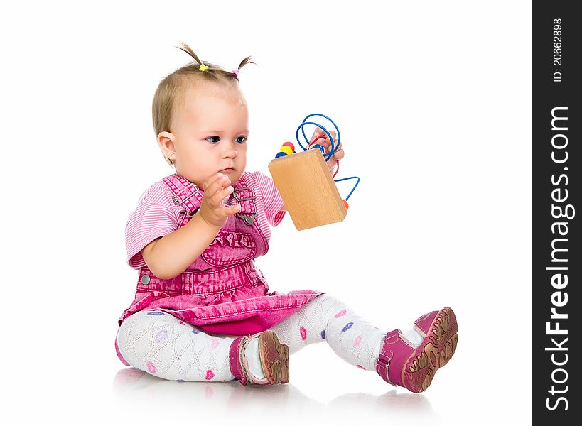 Small baby with developmental toy on a white background