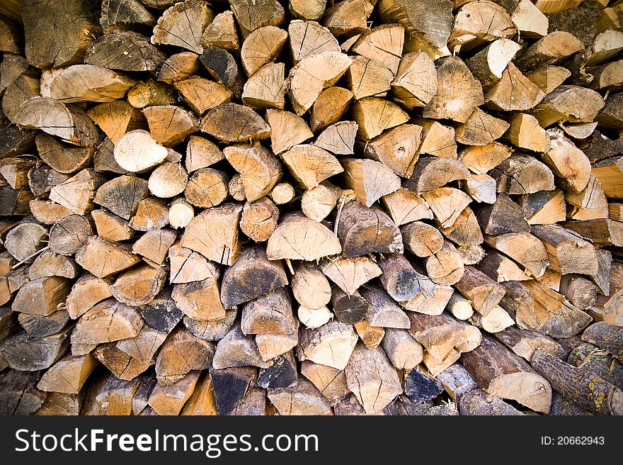 Firewood stock of a round tree trunks
