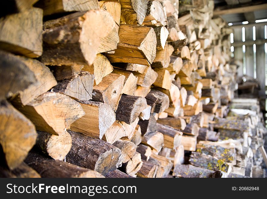 Firewood stock of a round tree trunks