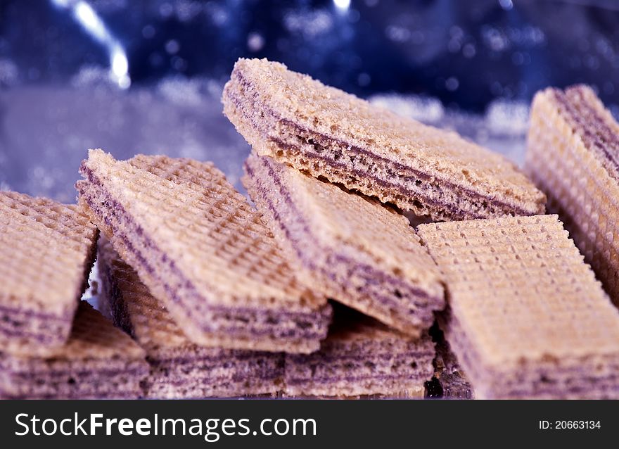 Stack of sweet wafer biscuits on cool foil background