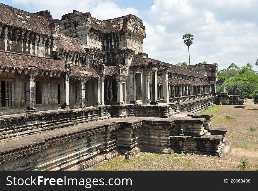 An ancient Khmer building in the territory of Angkor Wat, Cambodia, severely damaged earlier and reconstructed later.