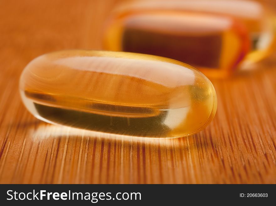 Medical pill against diseases on a wooden table.