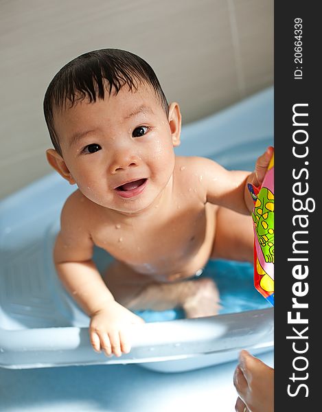 Asian Chinese toddler playing in bath tub