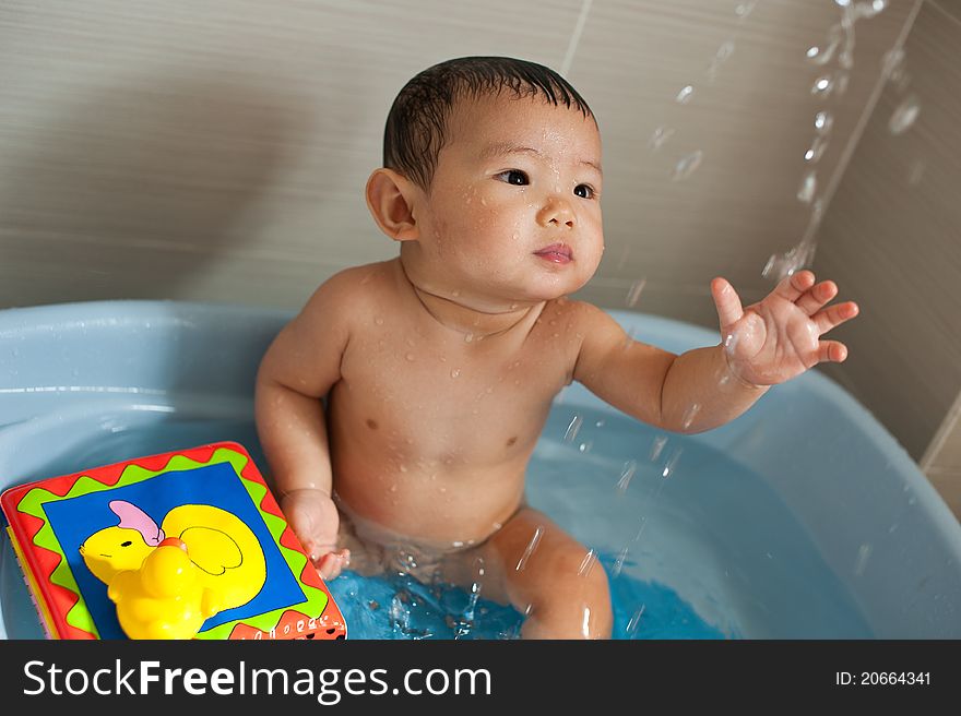 Asian Chinese toddler playing in bath tub