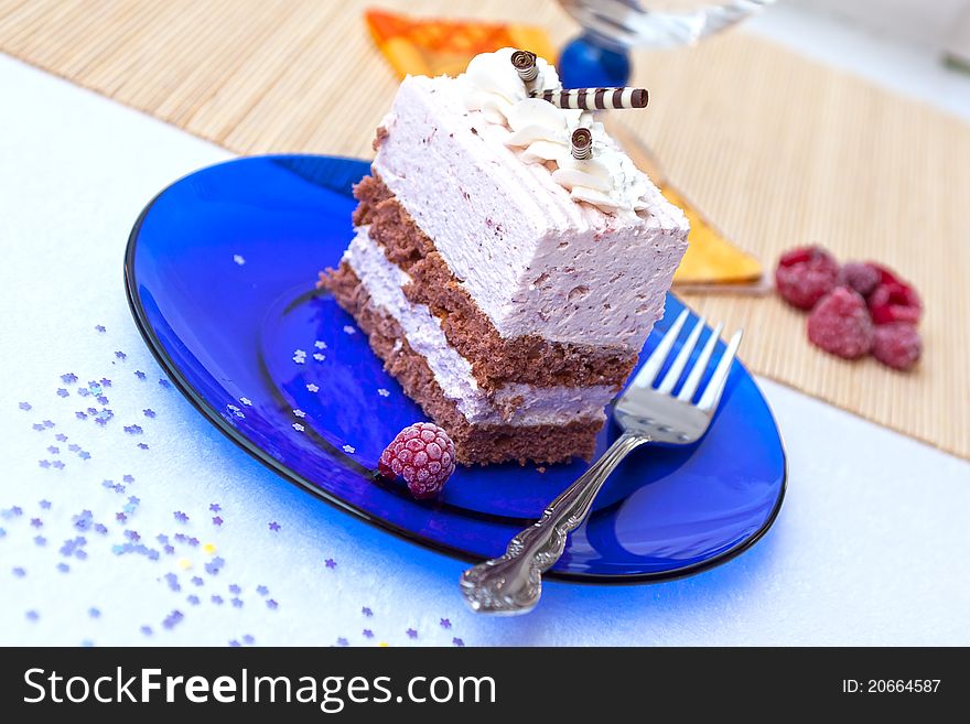 Fresh raspberry cake on blue plate