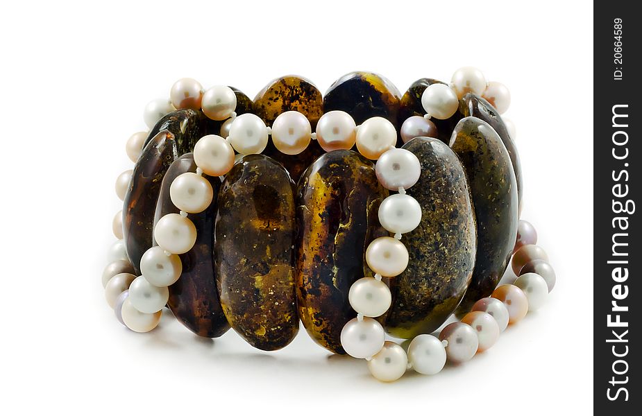 Bracelet of Baltic amber and beads necklace of pearl isolated on white background