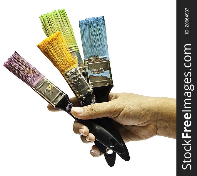 The hand of artist holding four of brushes on isolated white background. The hand of artist holding four of brushes on isolated white background