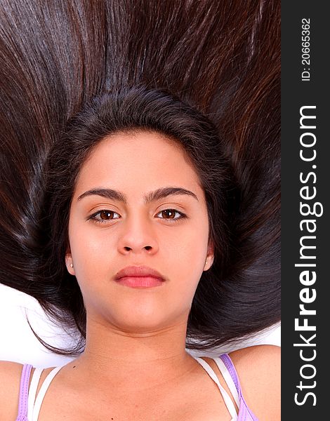 Young woman with dark brown long hair looking at camera. Young woman with dark brown long hair looking at camera