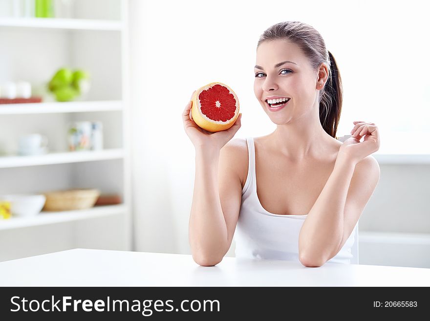 Beautiful girl holding a grapefruit. Beautiful girl holding a grapefruit