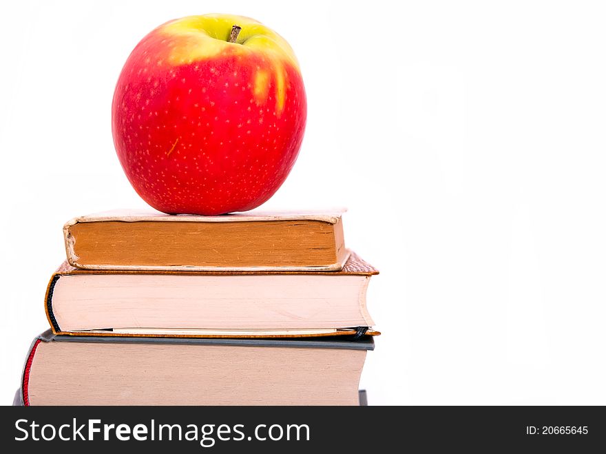 An apple on a book pile