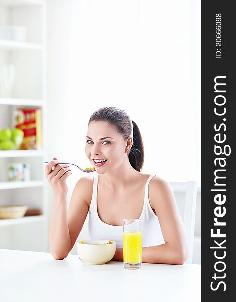 Beautiful young girl ate breakfast in the kitchen