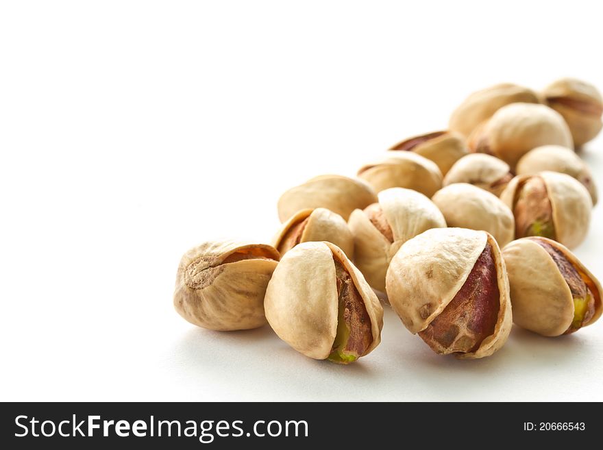 Pile of pistachios is on a white background