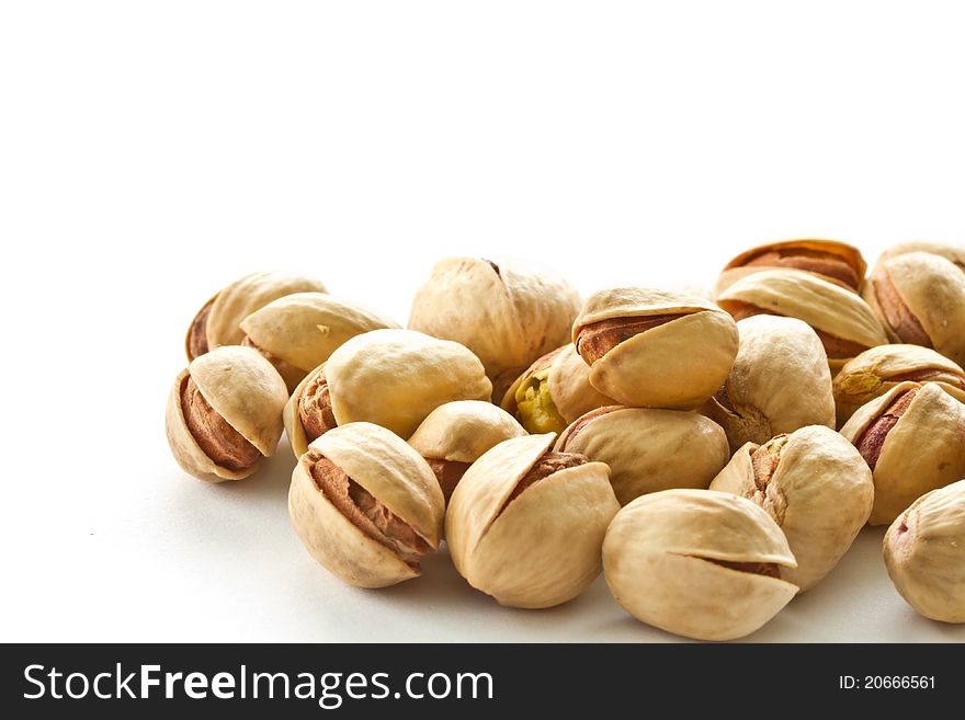 Pile of pistachios is on a white background