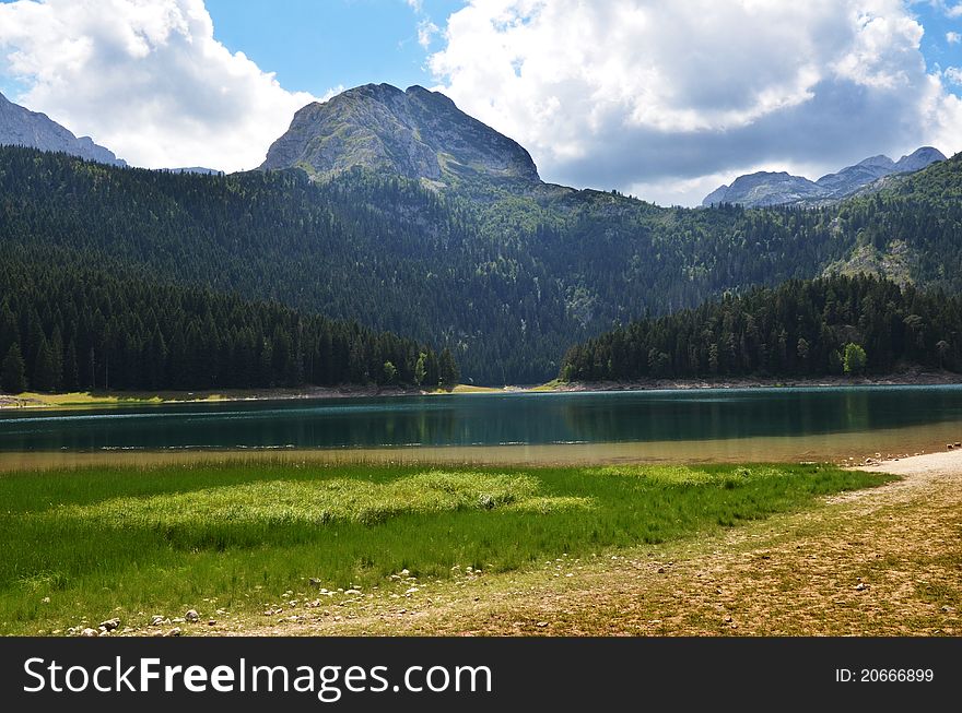 The landscape showing an amazing nature of Durmitor mountine and Black lake in Montenegro. The landscape showing an amazing nature of Durmitor mountine and Black lake in Montenegro.