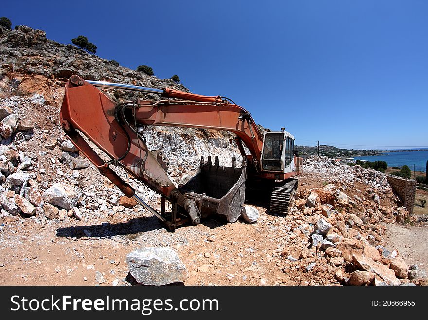 Excavator working on the slope of the quarry,fisheye. Excavator working on the slope of the quarry,fisheye