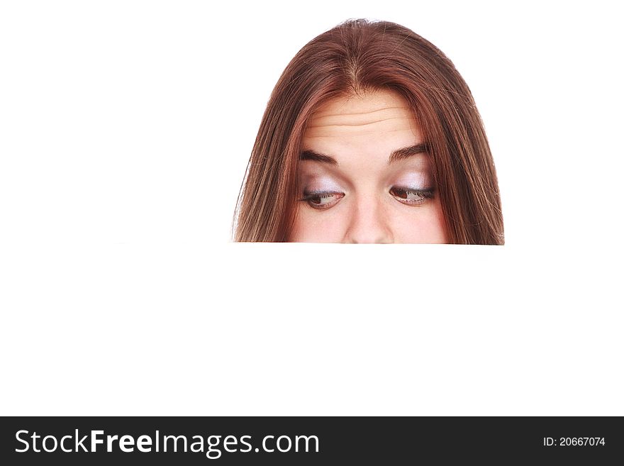 Portrait of a beautiful woman holding a blank billboard, looking out from behind it.