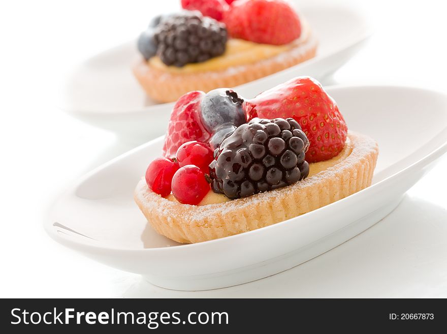 Photo of delicious pastry with berries on white background