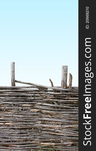 Old weathered fence on blue background