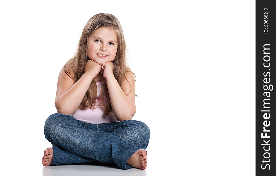 Cute happy little girl sitting on white background