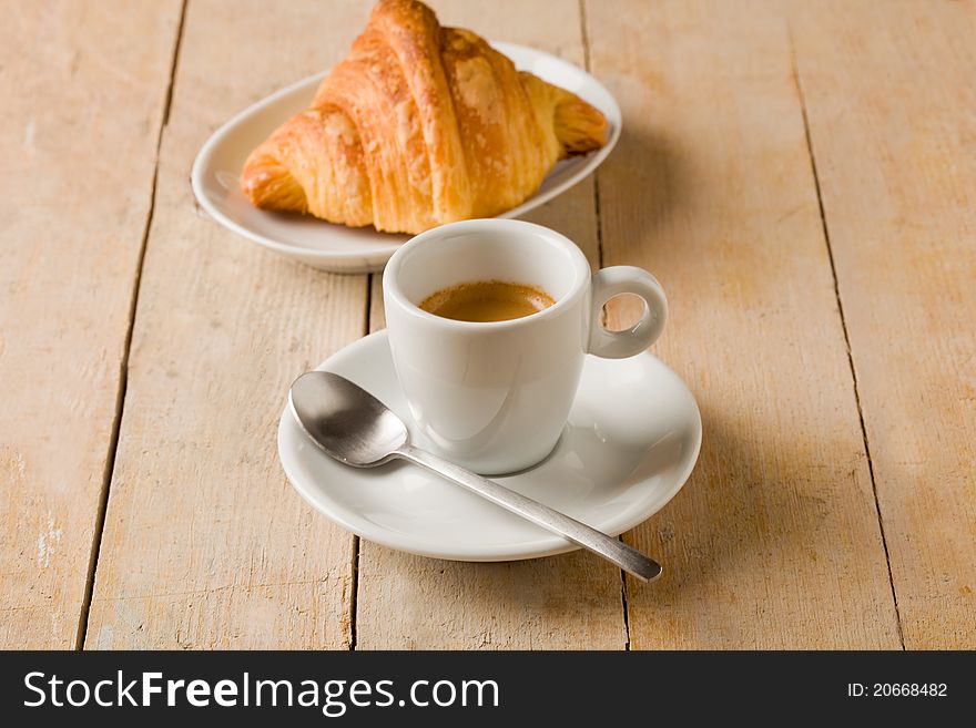 Coffee And Croissants On Wooden Table