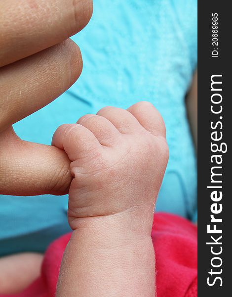 Newborn Baby Clutching Mothers Finger
