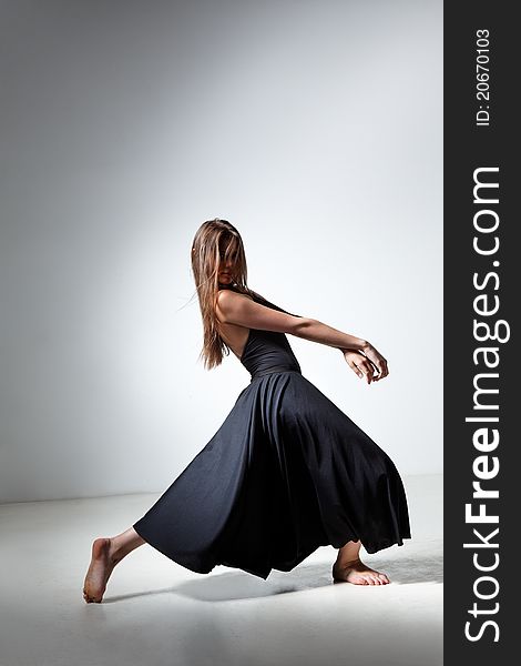 Young and beautiful dancer posing in studio. Young and beautiful dancer posing in studio