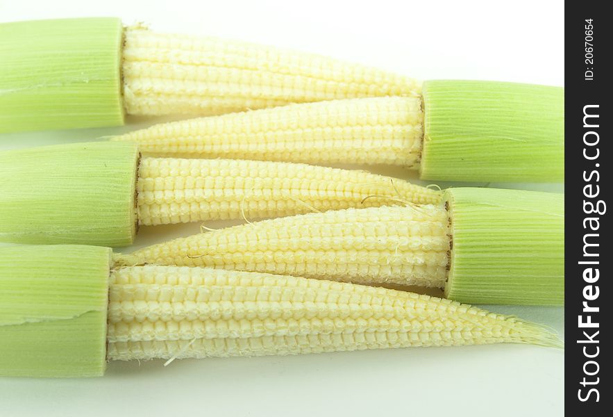 Baby corns on a white background put together. Baby corns on a white background put together.