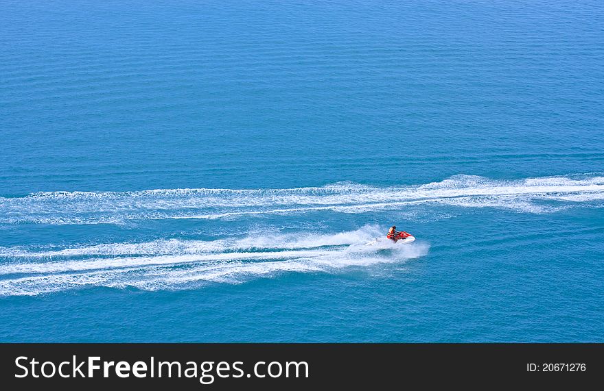 Jetski racing on blue water as background