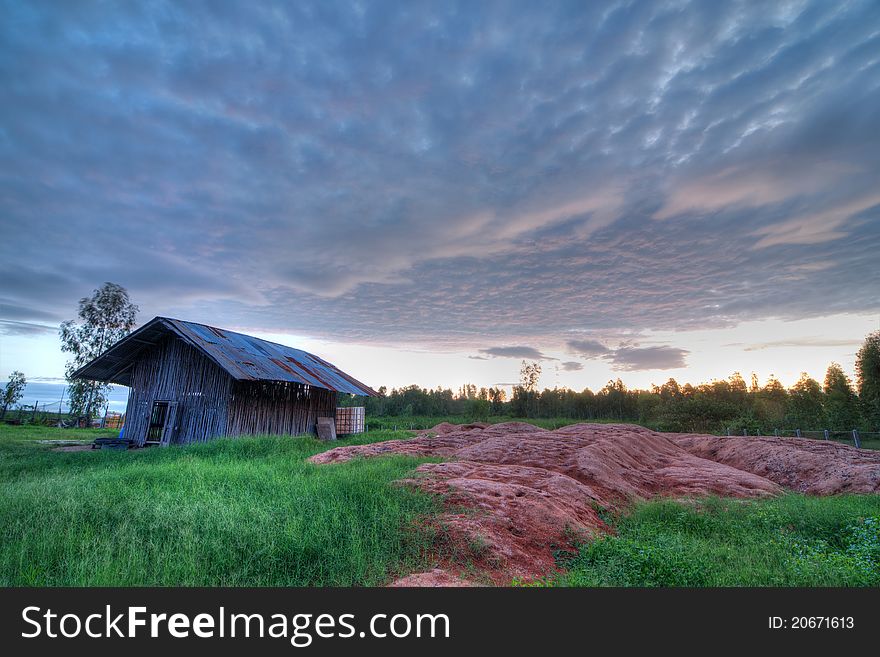 The wooden hut in the sunset time in this picture is in the rural area of northeastern thailand. It is used as the hen coop. The wooden hut in the sunset time in this picture is in the rural area of northeastern thailand. It is used as the hen coop.