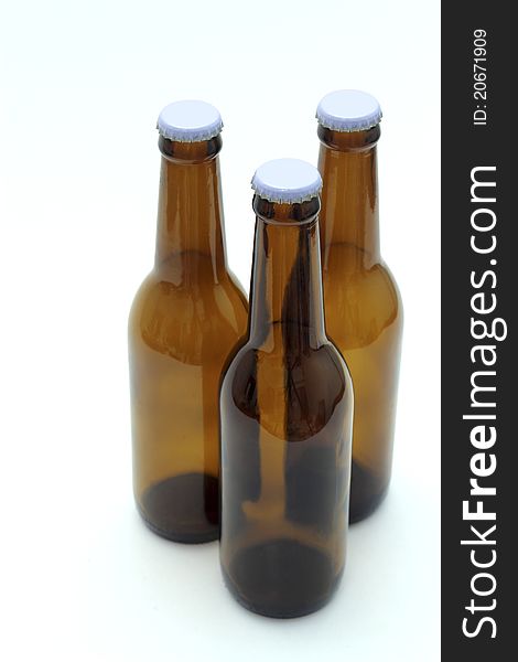 Three empty bottles of beer on white background