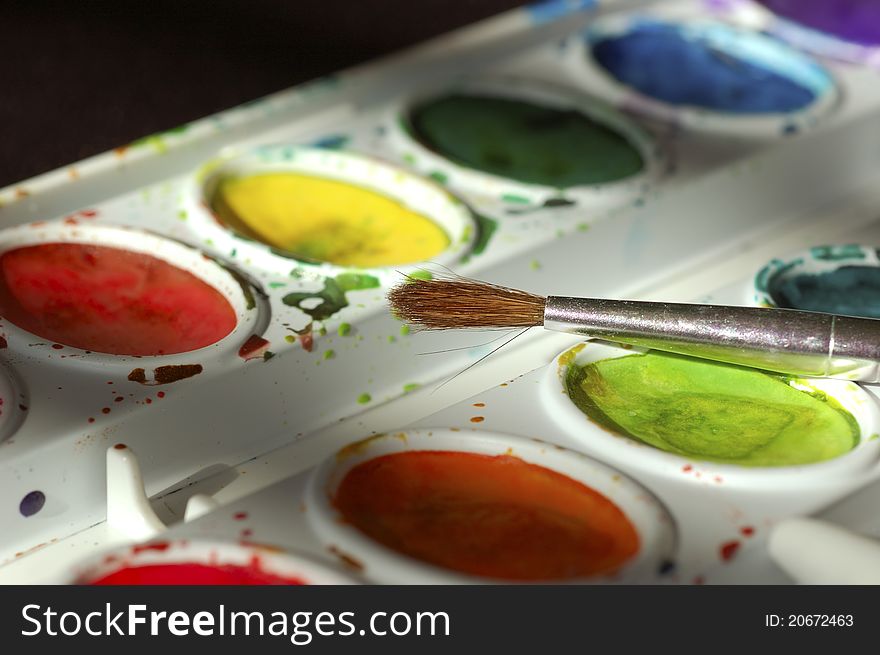 Closeup shot of watercolor paints and brush. Closeup shot of watercolor paints and brush.