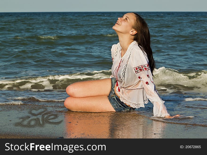 Beautiful brunette lying on the beach