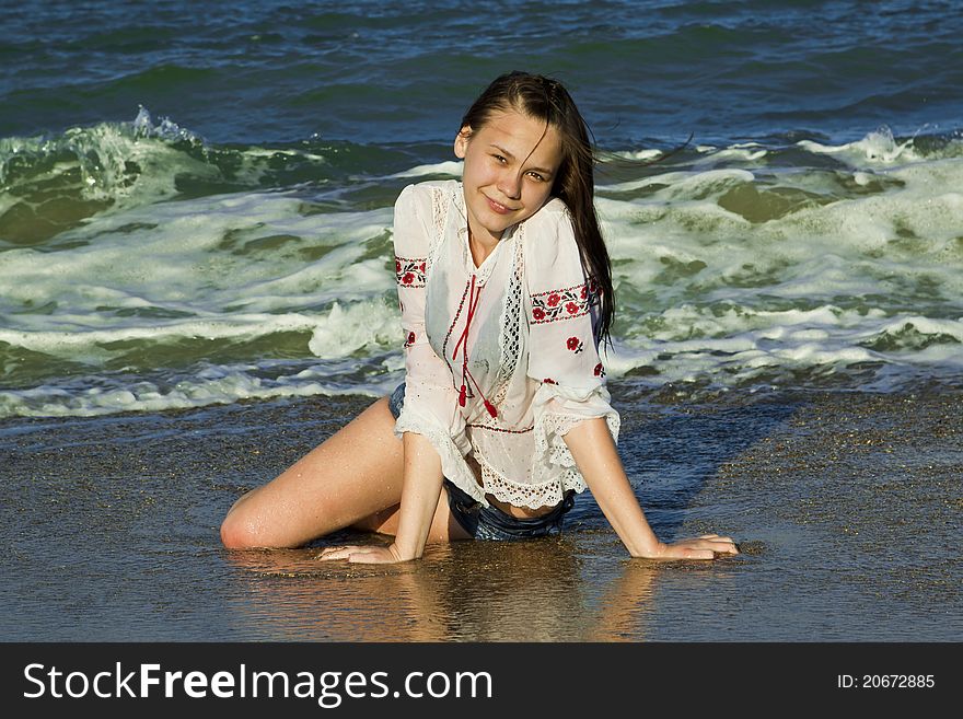 Beautiful brunette lying on the beach