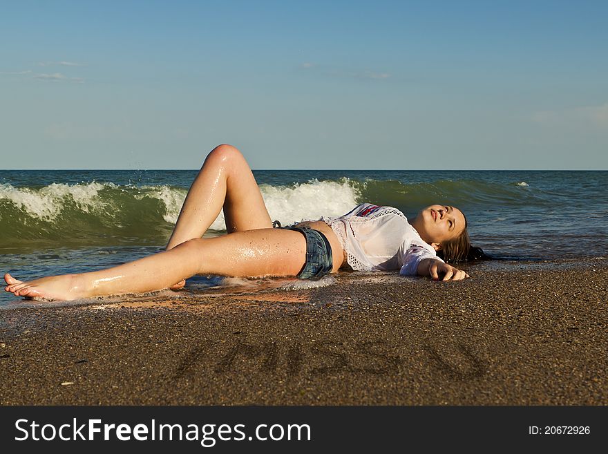 Beautiful brunette lying on the beach