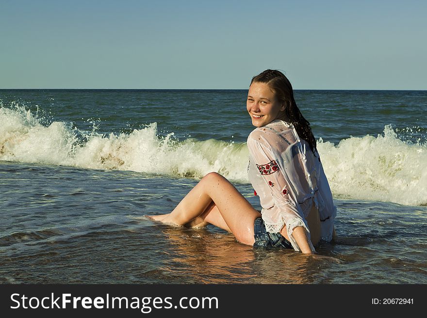 Beautiful brunette lying on the beach