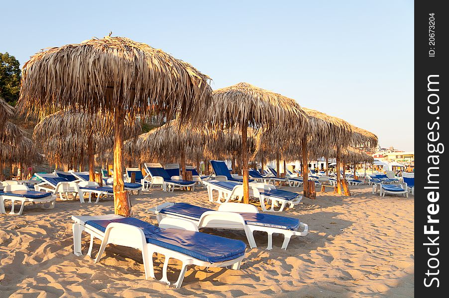 Black sea beach with palms, umbrella and chairs. Black sea beach with palms, umbrella and chairs