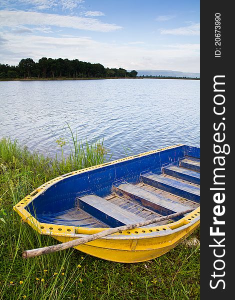 Yellow boat on the bank of the lake