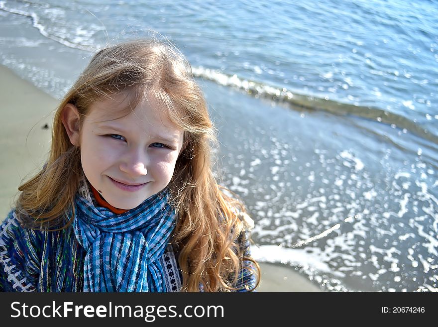 Smiling girl with the sea at the background. Smiling girl with the sea at the background