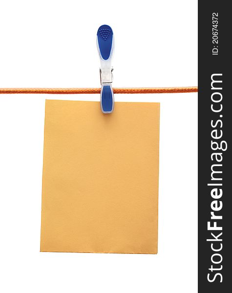 Cloth peg holding a paper sheet. Cloth peg holding a paper sheet