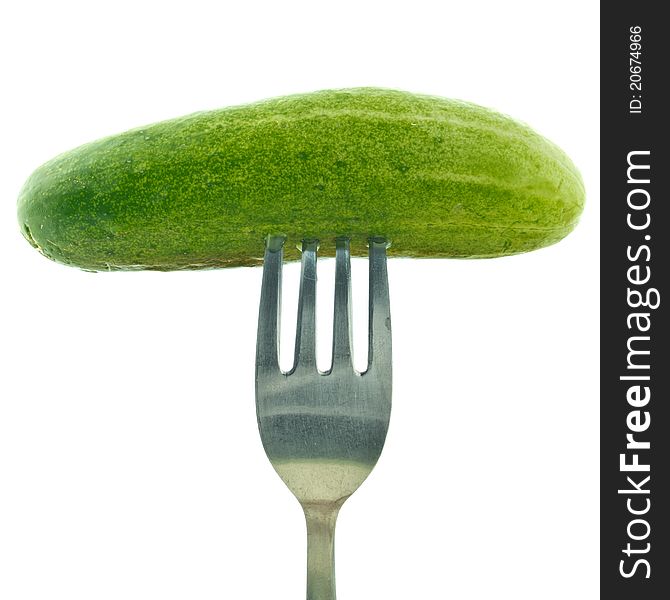 Fork stuck in cucumber isolated on white background. Fork stuck in cucumber isolated on white background