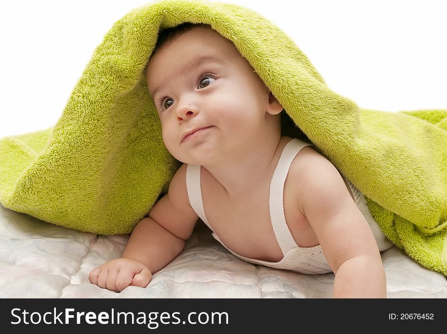 Beautiful baby with the green towel on white background. Beautiful baby with the green towel on white background