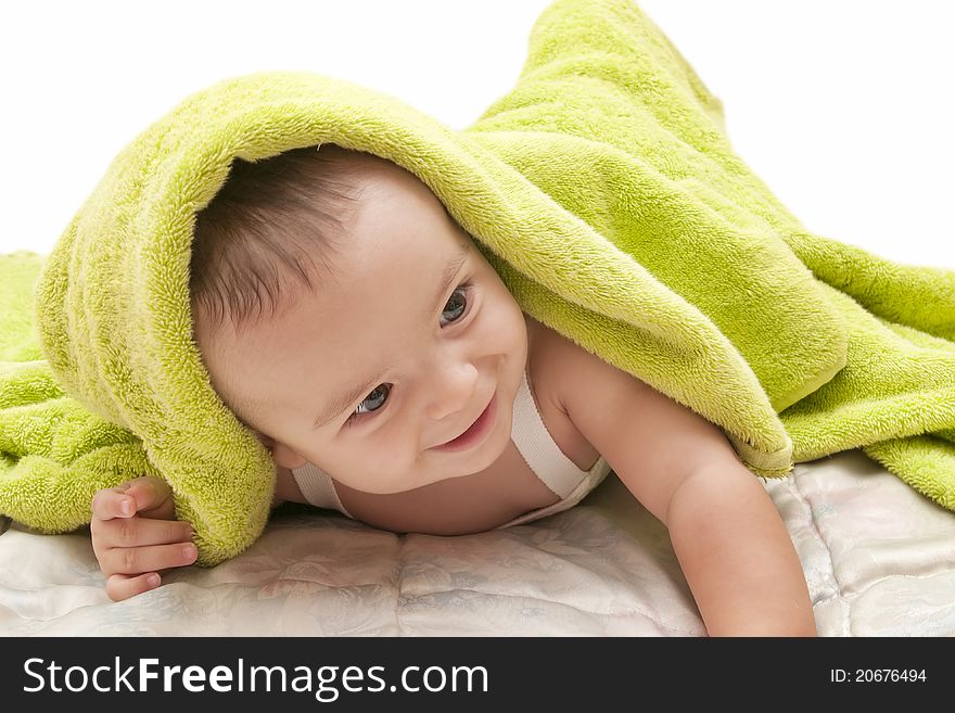 Beautiful baby with the green towel on white background. Beautiful baby with the green towel on white background