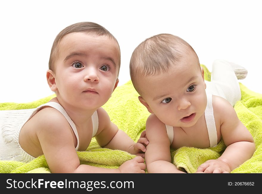 Beautiful babies with the green towel on white background. Beautiful babies with the green towel on white background