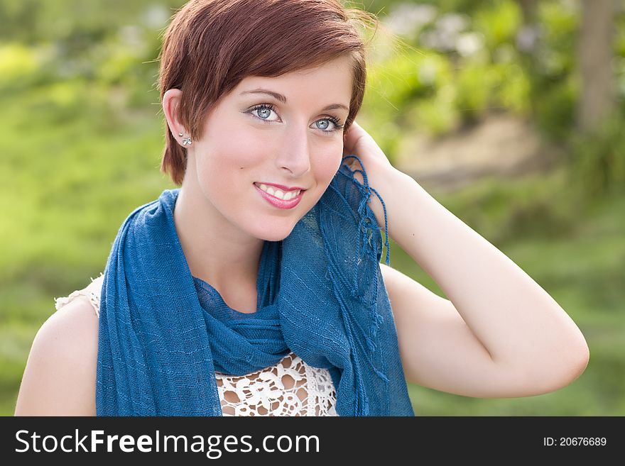 Outdoor Portrait of Pretty Blue Eyed Young Red Haired Adult Female with Blue Scarf. Outdoor Portrait of Pretty Blue Eyed Young Red Haired Adult Female with Blue Scarf.