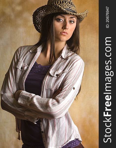Teen cowgirl in tank top and Hat with long dark hair