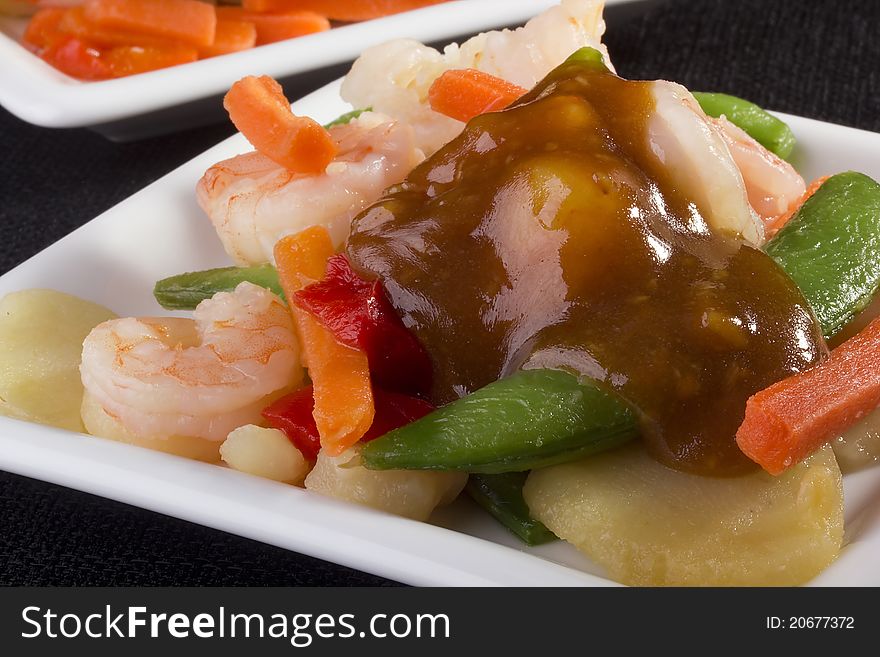 Close-up photograph of a shrimp salad on a white plate.